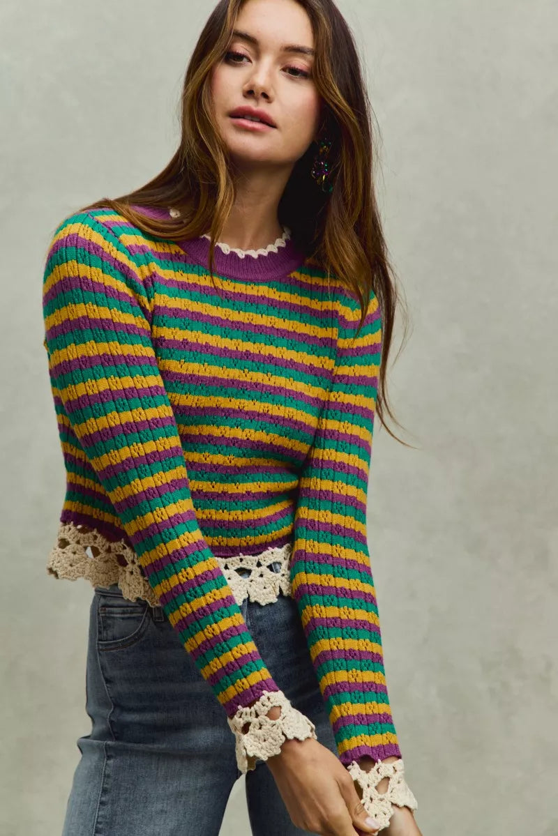 Striped cropped knit top with purple neckline and crochet lace cuffs and hem