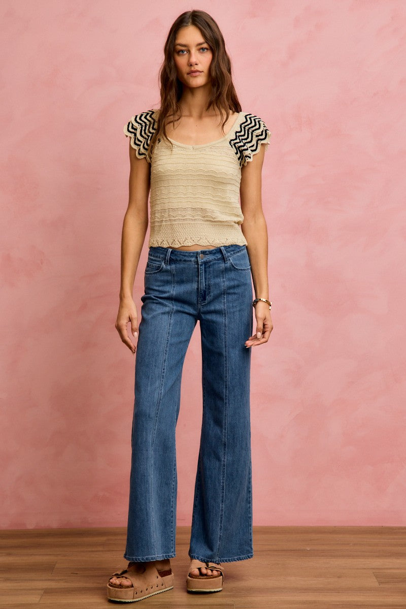 Oatmeal knit top with wavy texture and black-trim flutter sleeves