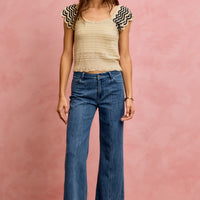 Oatmeal knit top with wavy texture and black-trim flutter sleeves