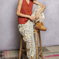 Rust orange sleeveless knit V-neck sweater vest with button front detail