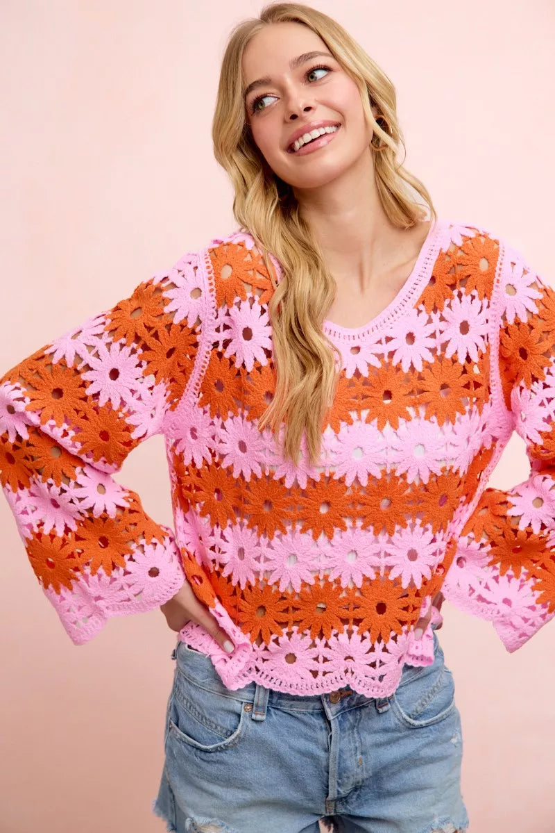 Orange crochet knit top with pink floral lace pattern, long sleeves, scoop neckline.