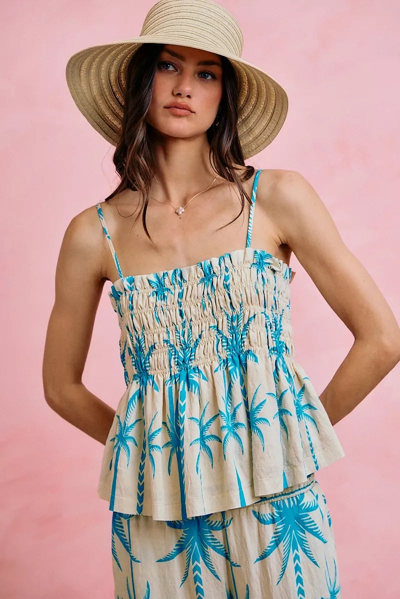 Blue palm-print smocked cami top with adjustable straps and ruffled peplum hem