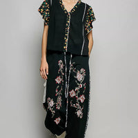 Black ruffle-sleeve blouse with floral V-neck trim and vertical contrast piping