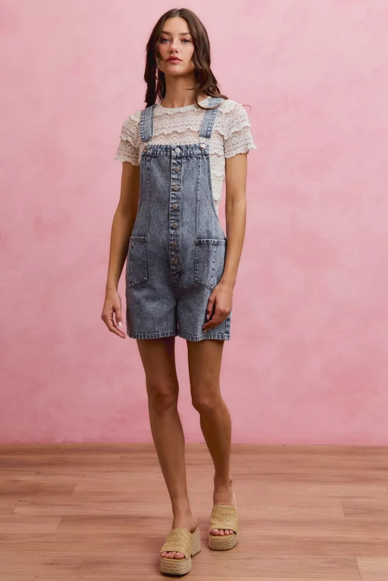 Light-wash denim romper with adjustable straps and front button placket