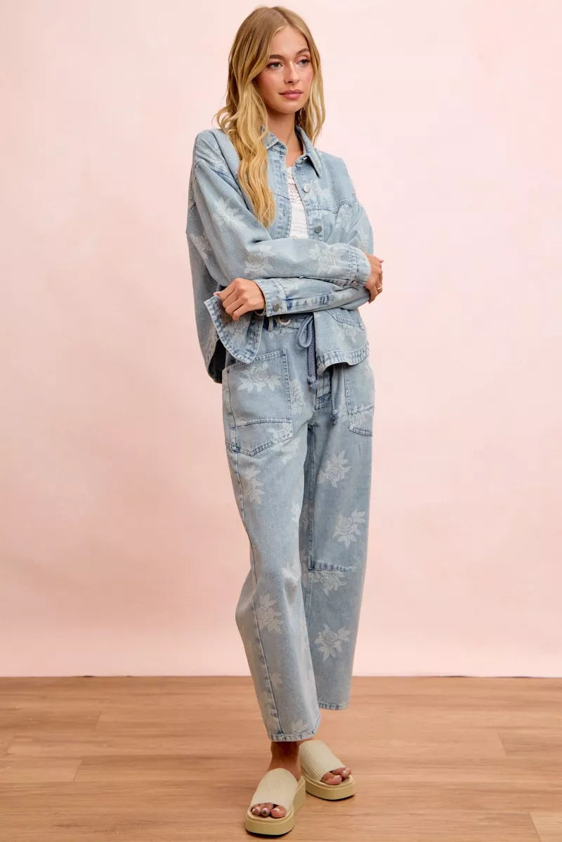 Light blue washed denim jacket with white floral print, button front and side pockets