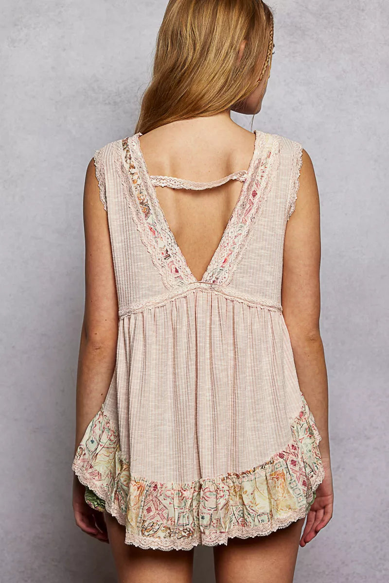 Pale pink sleeveless top with lace V-back and floral ruffle hem