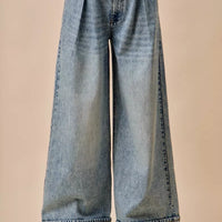 Light-wash mid-rise denim jeans with pleated wide-leg silhouette and button closure