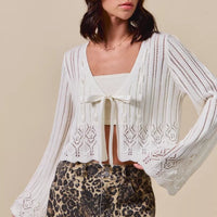 Off-white textured open-front ribbon-tie cardigan with long wide sleeves