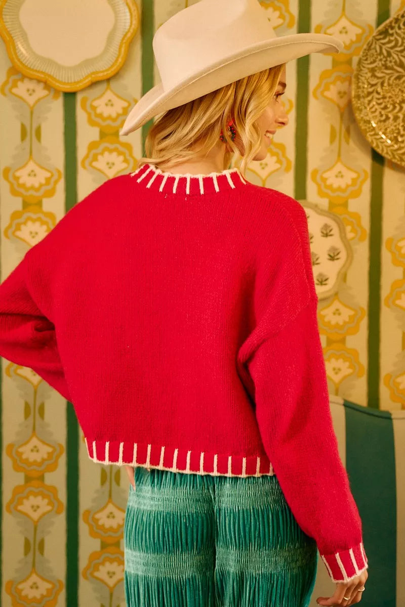 Red sweater back with white fringe-trim collar and cuff bands