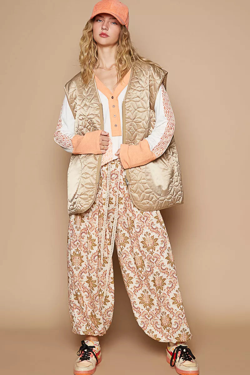 Quilted mocha front-zip vest with V-neck, ribbed trim, and side pockets