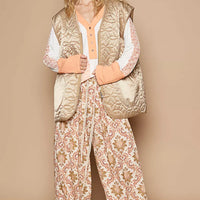 Quilted mocha front-zip vest with V-neck, ribbed trim, and side pockets