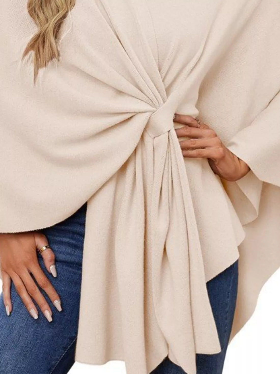 Close-up of ivory shawl cape front tie with gathered pleats at the waist