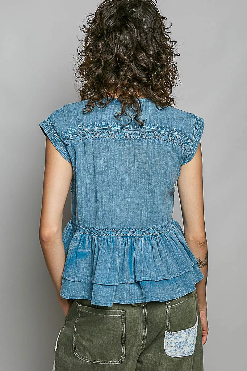 Denim blue sleeveless pintuck embroidered blouse, back view with ruffle peplum