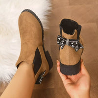 Tan suede ankle boots with round toe, block heel, jeweled bow, and plush lining