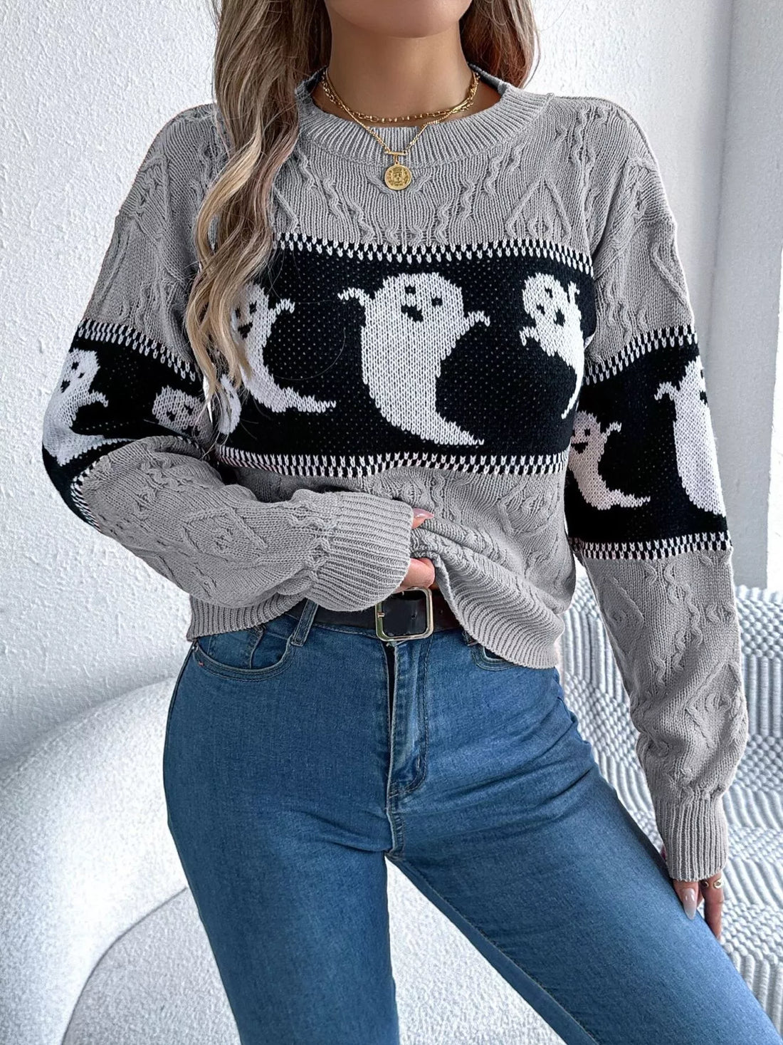Gray crewneck sweater with ghost graphic panel, textured knit, and contrast cuff stripes