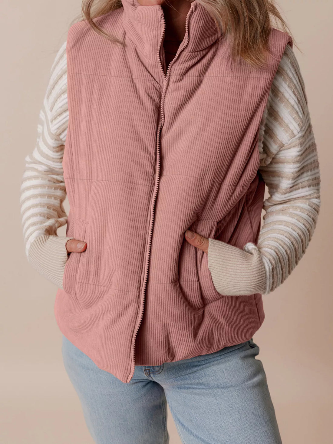 Dusty pink corduroy puffer vest with stand collar, full front zipper, and side pockets.