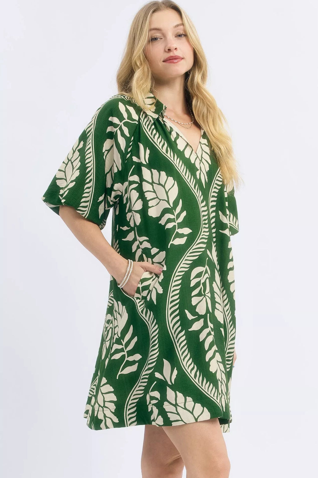 Green and cream leafy print mini dress with V-neck and loose short sleeves
