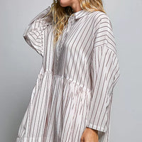 Side view of striped shirt dress with collared button placket, gathered waist, long sleeves