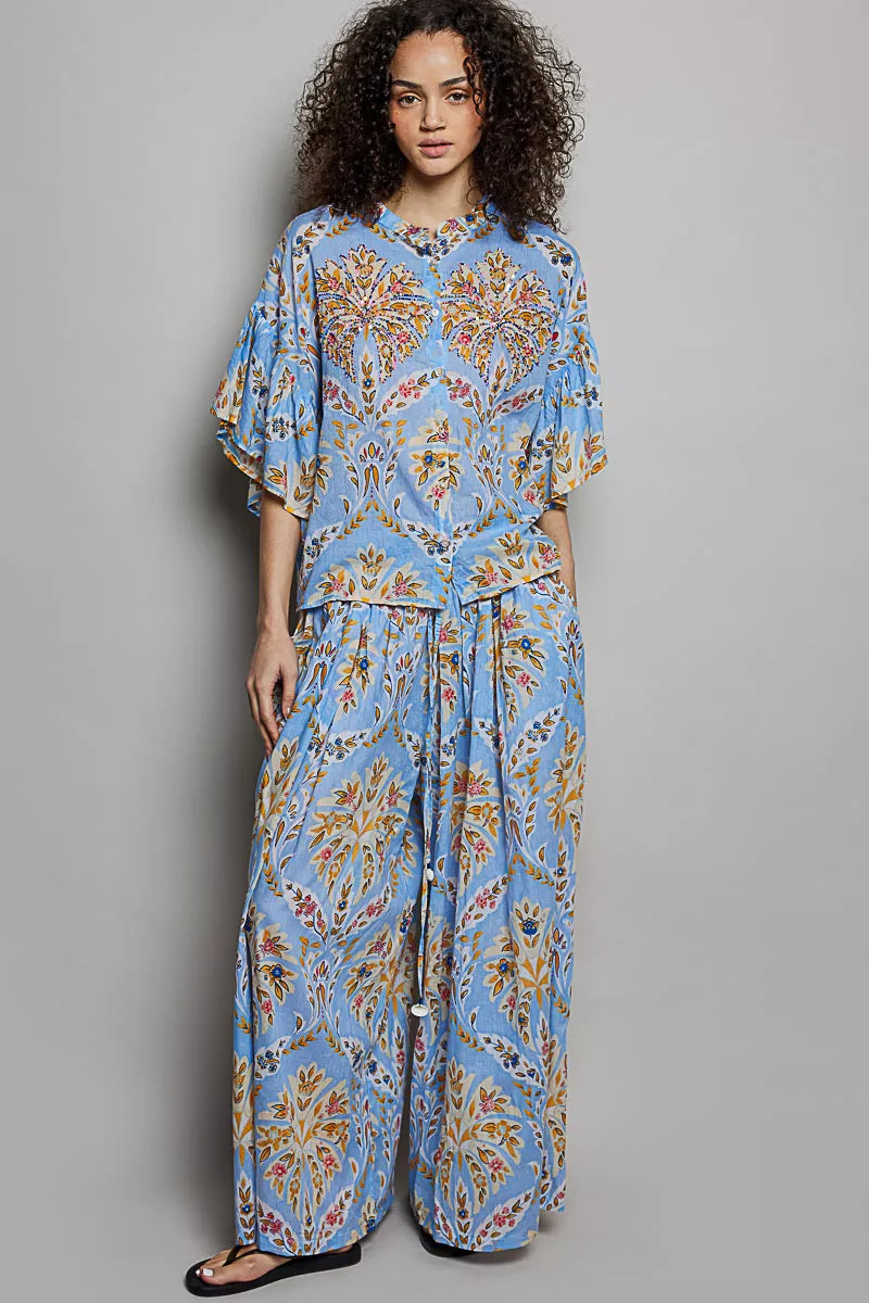 Blue floral printed woven shirt with ruffle sleeves and elastic waist, front full view