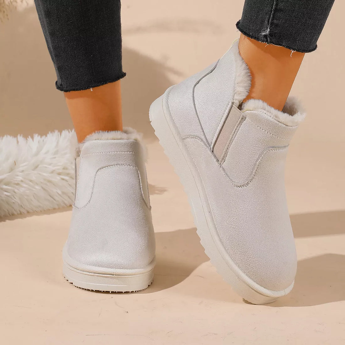 White plush-lined ankle boots with side elastic panels and padded collar