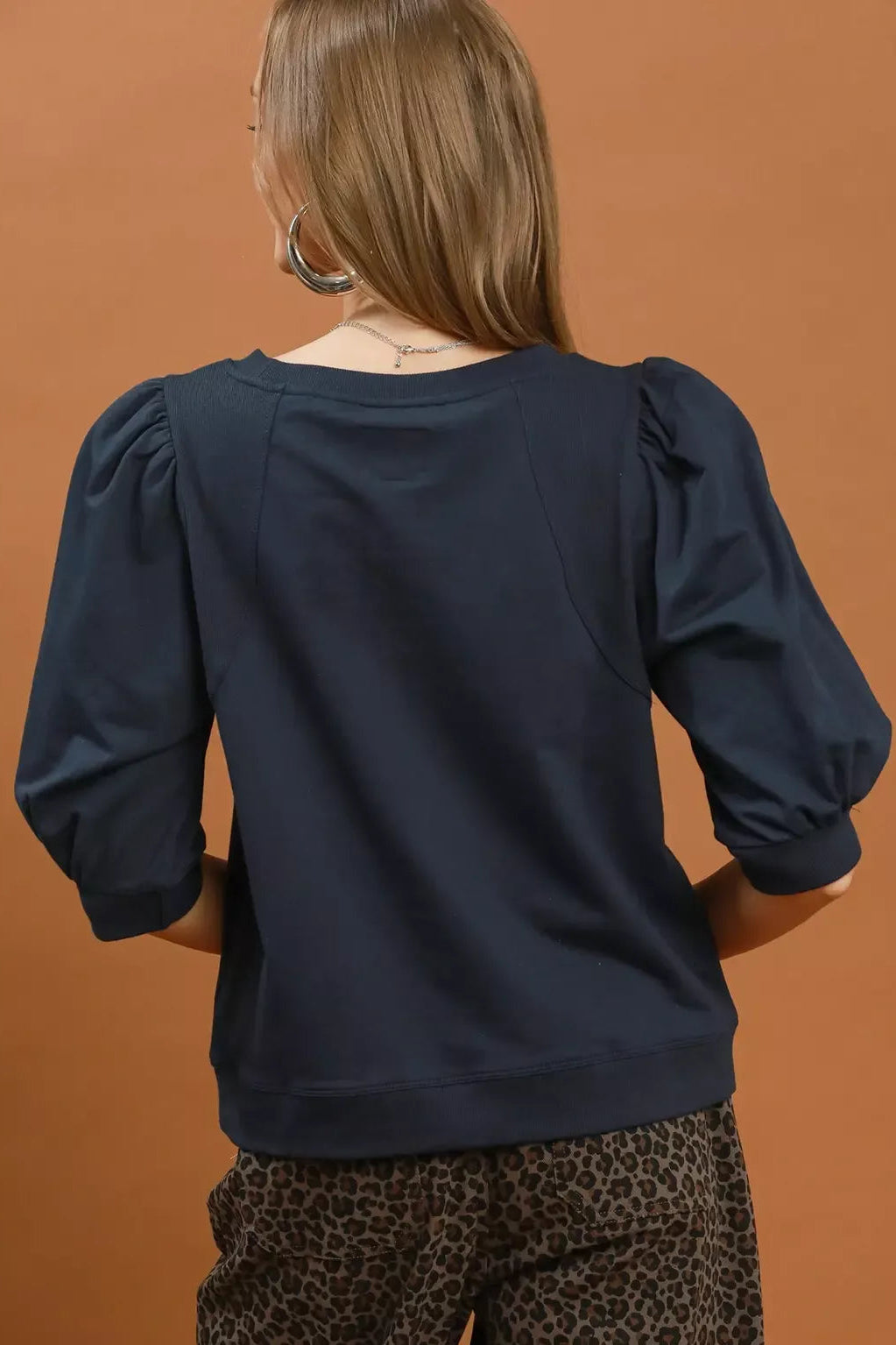 Navy sweatshirt with puffed sleeves, back view, crew neckline
