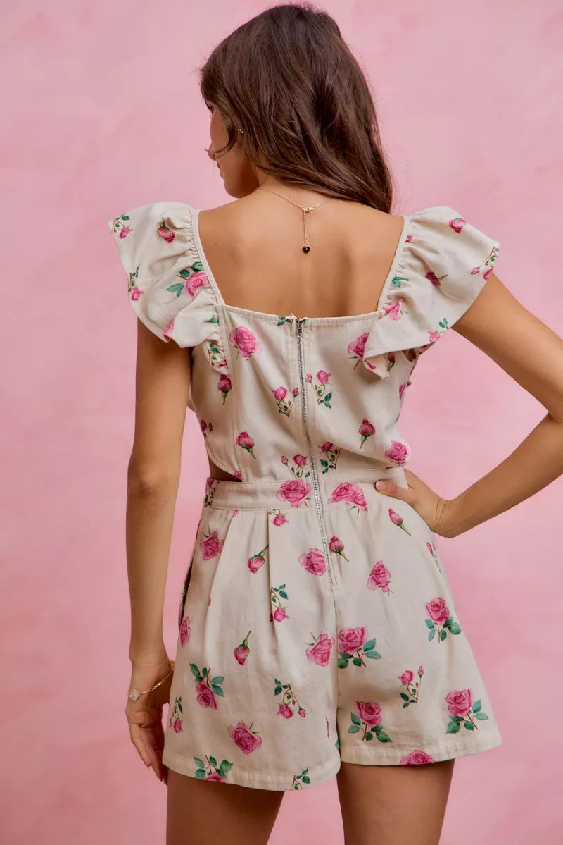 Ivory floral romper with open back and ruffled cap sleeves, pink rose print