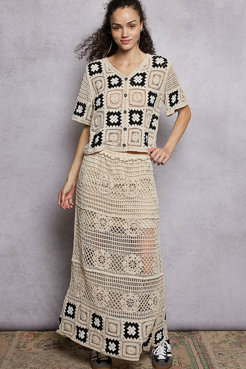 Crochet maxi skirt with ruffled waist and black granny-square motifs on the hem