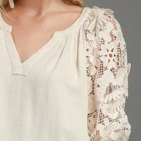 Oatmeal top with V-neck and 3/4 puff sleeve covered in 3D floral lace detail