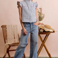 Blue-and-red striped twill sleeveless vest top with ruffled armholes and hidden buttons