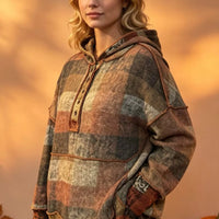 Plaid fleece hoodie with dropped shoulders, front half-zip, kangaroo pocket, side view.