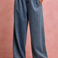 Women's denim wide-leg jeans with elastic ruffled waistband and visible back seam