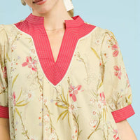 Floral dress neckline with pink V-placket and contrast puff sleeves, butter-yellow