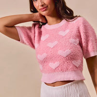 Pink cropped knit sweater with small white hearts, crew neck, short sleeves