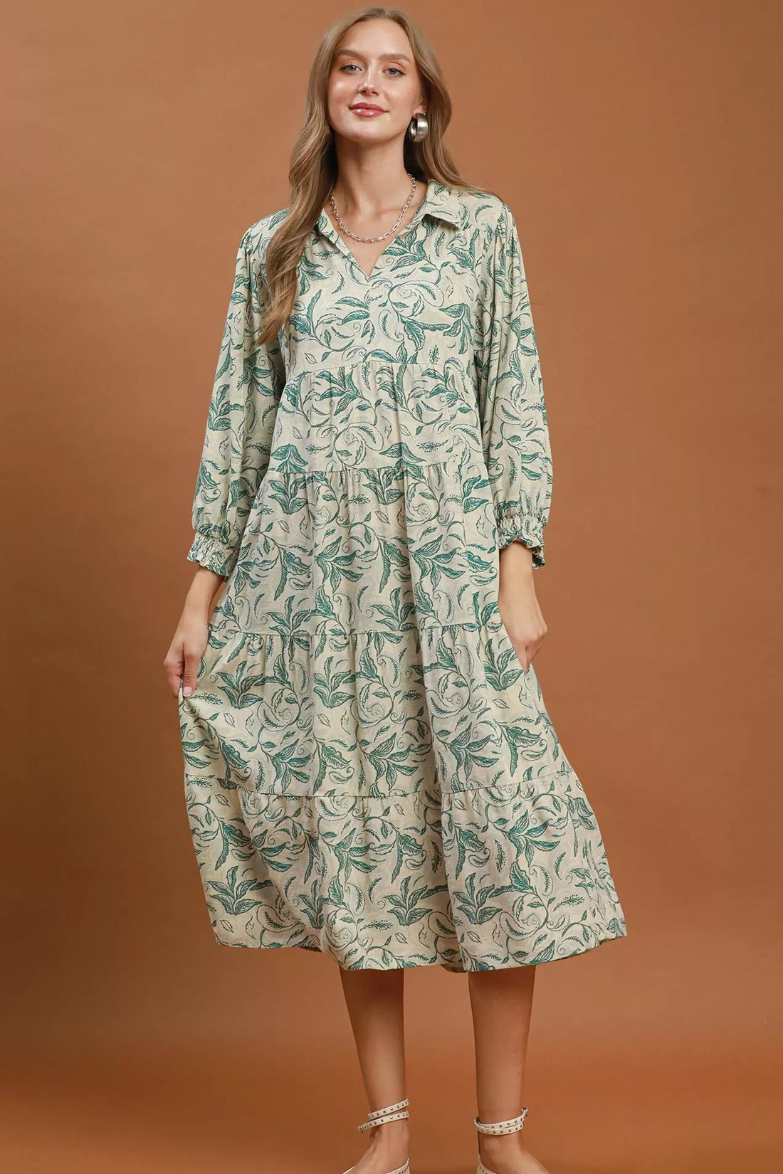 Green linen botanical print tiered midi dress with gathered skirt tiers and long sleeves