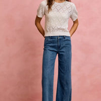 Mid-rise stretch denim jeans, straight-to-wide flared silhouette with belt loops