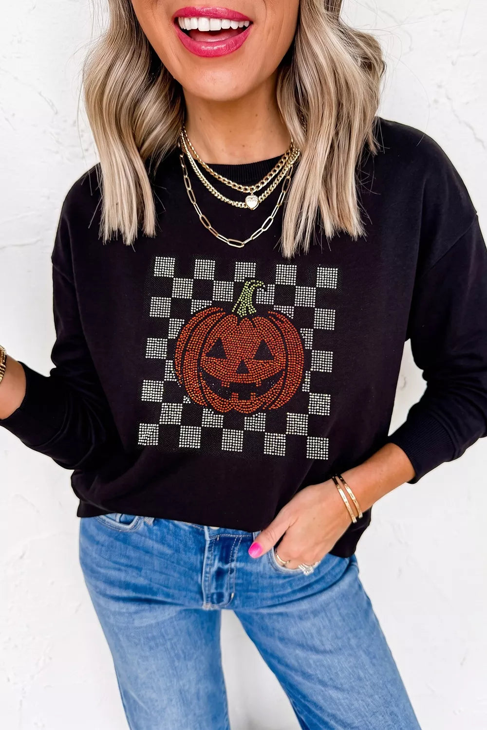 Black long sleeve sweatshirt with rhinestone pumpkin checkerboard front detail