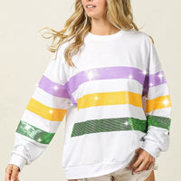 White pullover sweatshirt with sequin horizontal stripes across chest and long sleeves