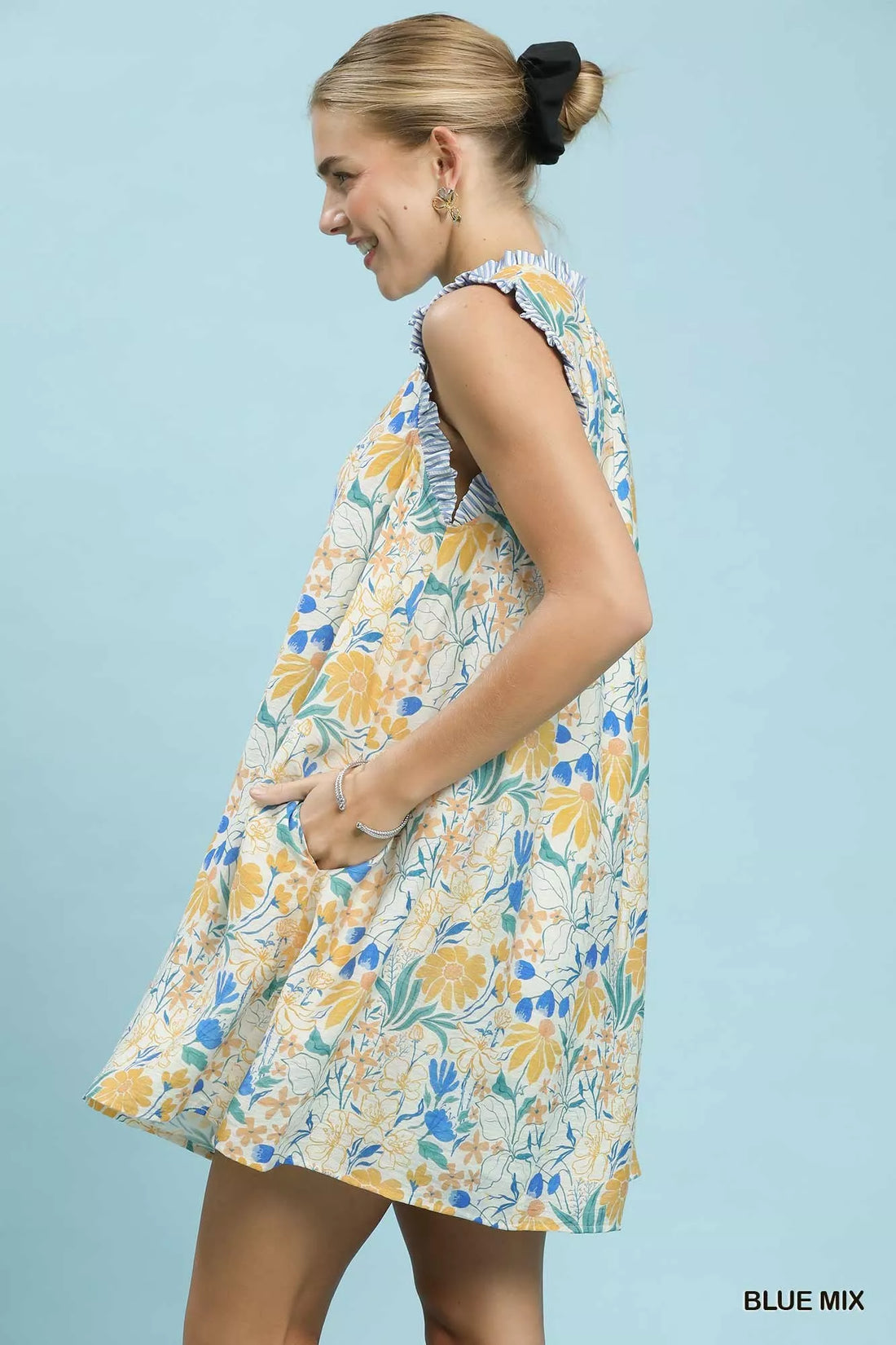Floral babydoll dress, sleeveless with gathered neckline, side view of blue-yellow print