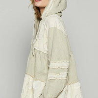 Beige hooded color-block jacket, raw hem and frayed seams visible from side