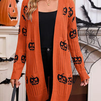 Orange open-front knit cardigan with black pumpkin jack-o'-lantern motifs, long sleeves