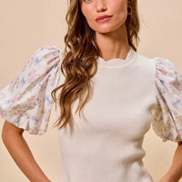 White knit sweater top with floral puff sleeves and scalloped sleeve trim