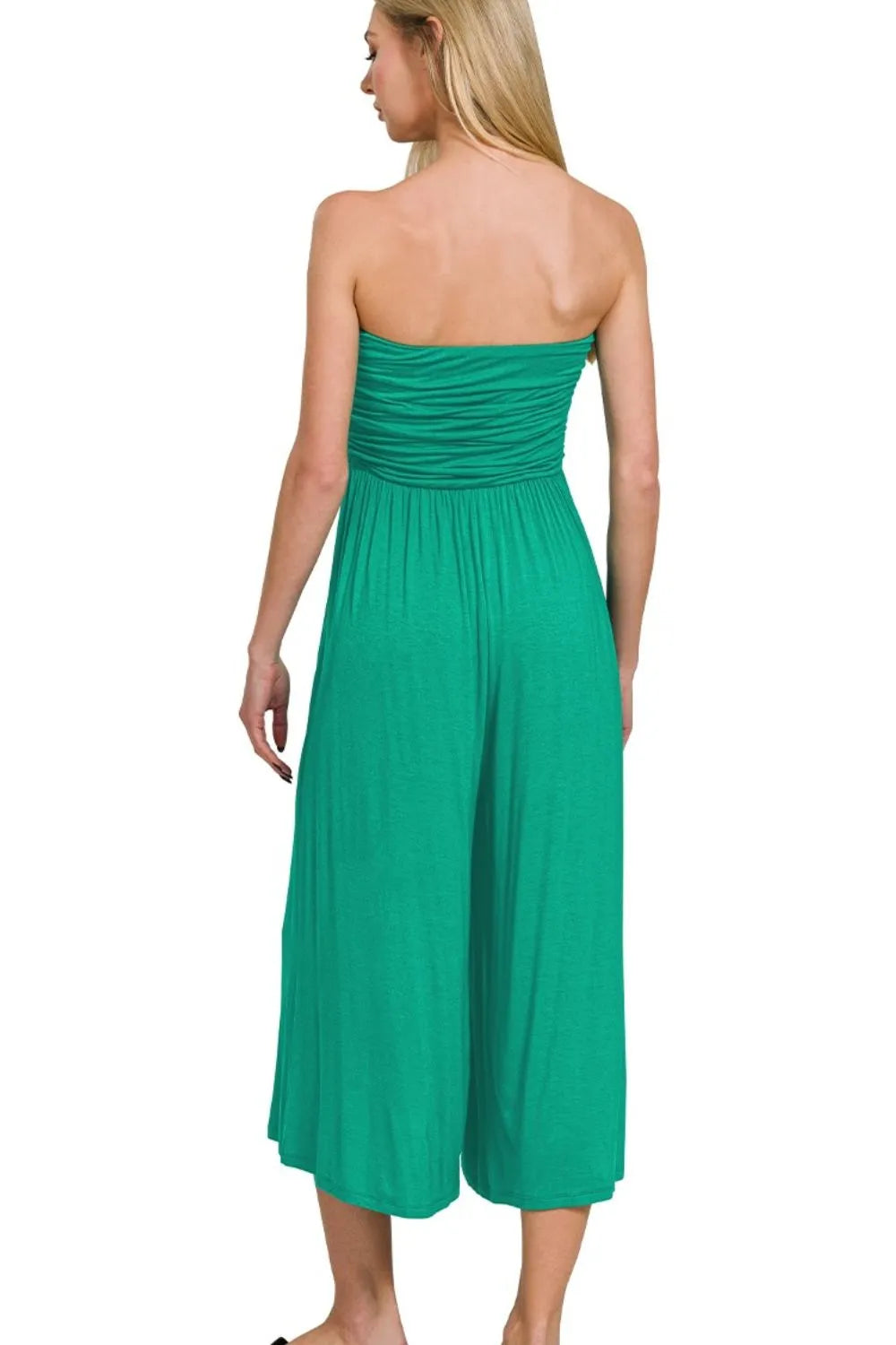 Green strapless jumpsuit with ruched back and flowing tiered skirt