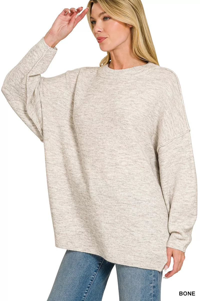 Oversized bone melange sweater with round neck, exposed seams, long sleeves