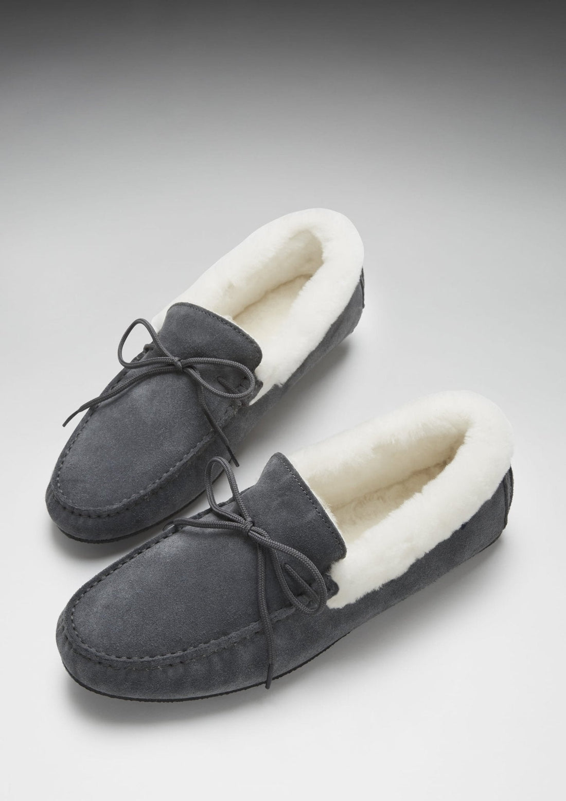 Pair of slate grey suede slippers with cream sheepskin lining and lace ties