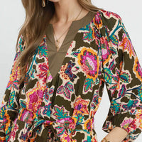 Close-up of belted midi dress: V-neck, long sleeves, dark olive floral print