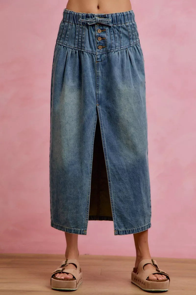 Washed denim pleated midi skirt with front slit and button fly detail