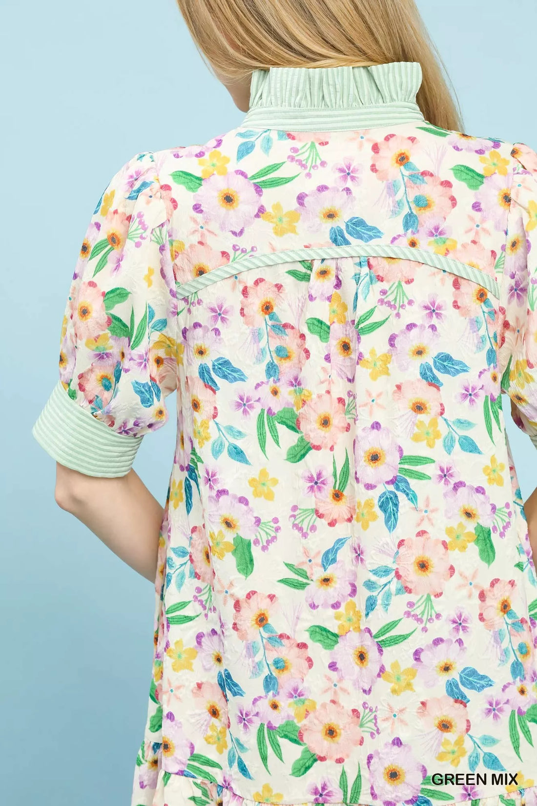 Back yoke of green floral babydoll dress with ruffled collar and gathered tiers