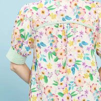 Back yoke of green floral babydoll dress with ruffled collar and gathered tiers