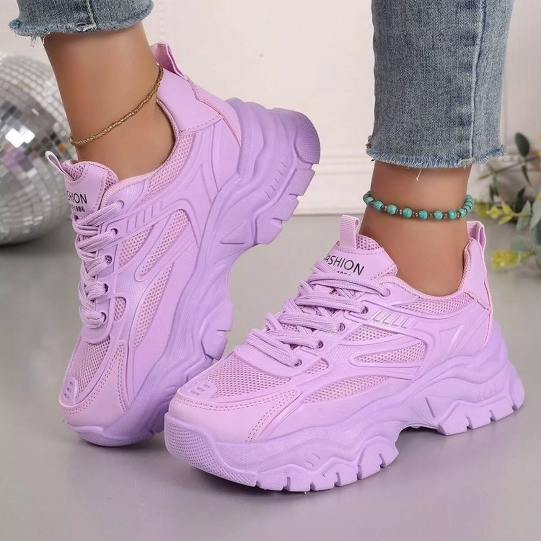 Purple chunky platform sneakers, lace-up with mesh panels and molded tread sole.
