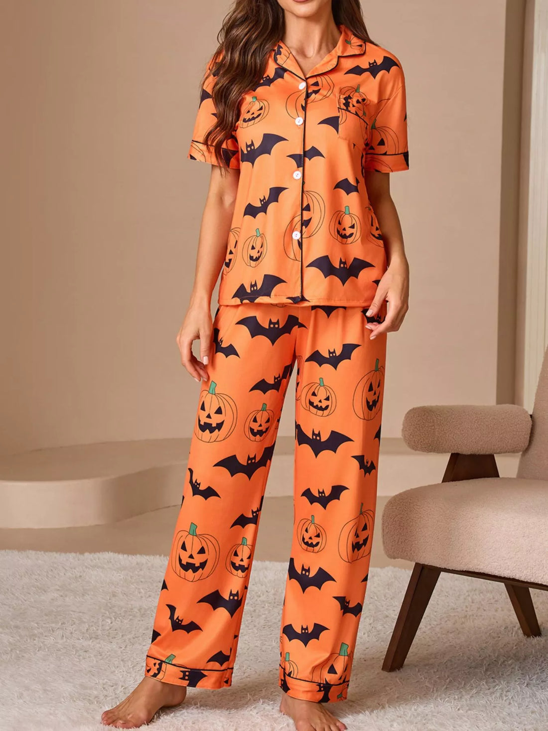 Orange short-sleeve button pajama set with pumpkin and bat print, matching lounge pants